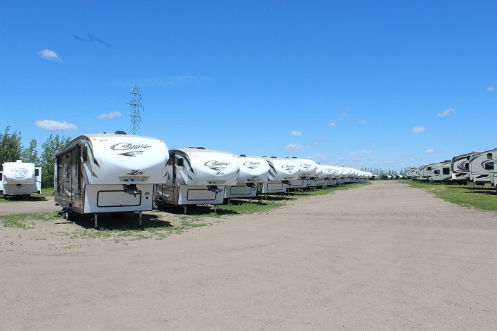 A row of RV campers in the lot. 